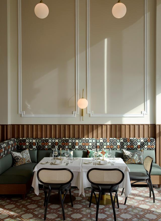 Elegant restaurant corner with patterned seating, white tablecloth and vintage tiled floor at ON Residence Hotel